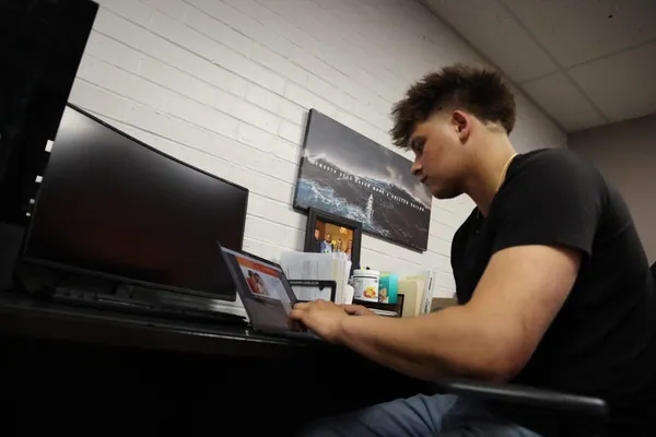 Team member working at a laptop in an office.