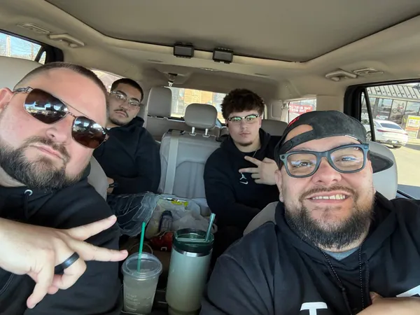 Team selfie inside a vehicle.