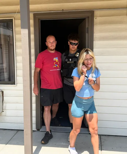 Three people at the entrance of a house.