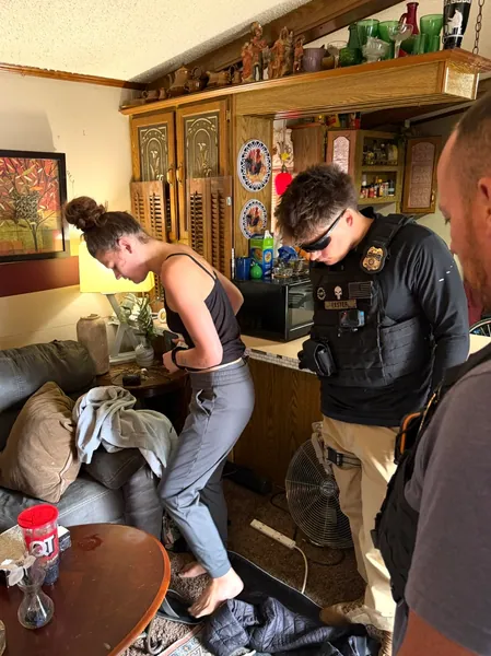 People gathered inside a furnished living room.
